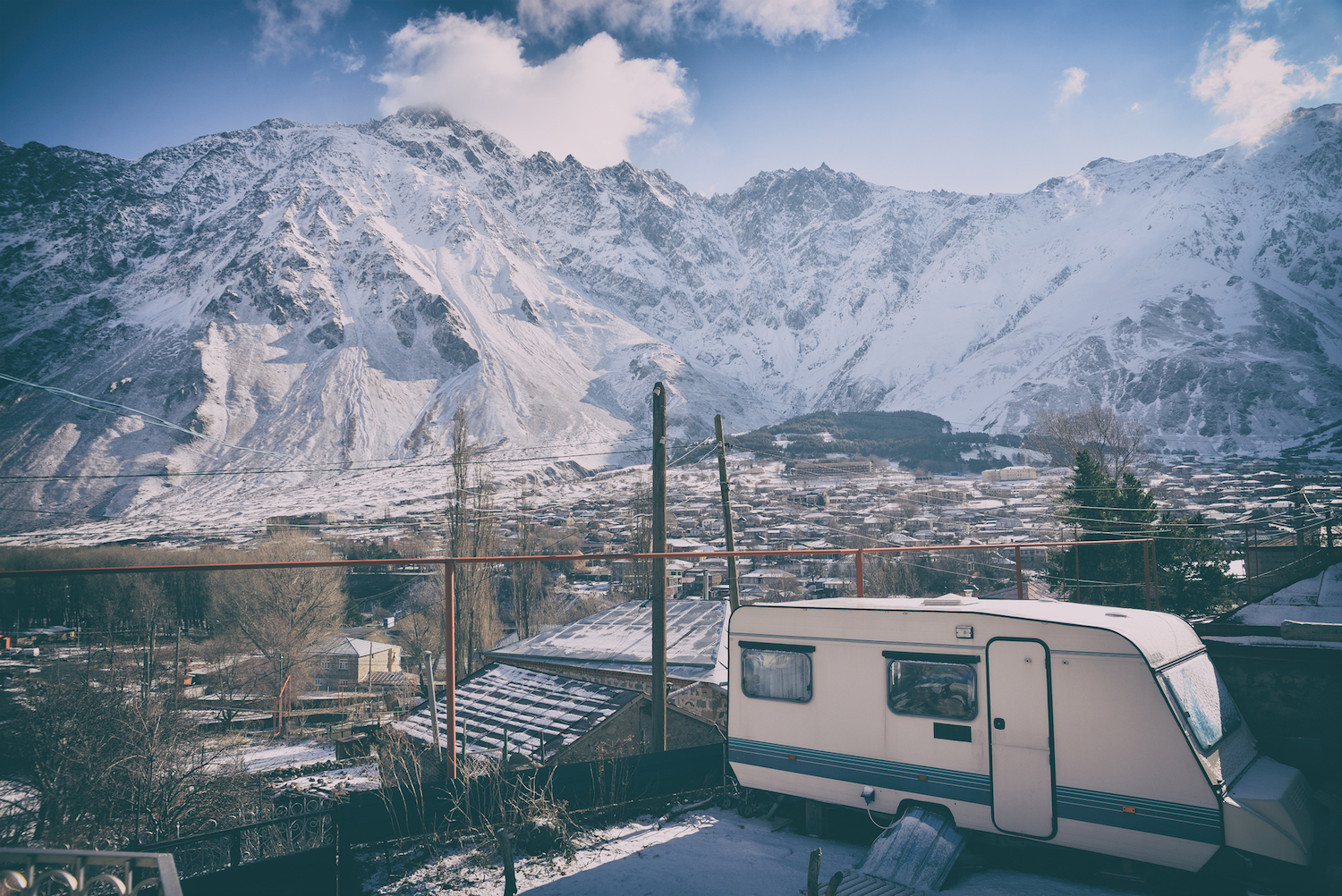 An RV parked on a lot with snow all around